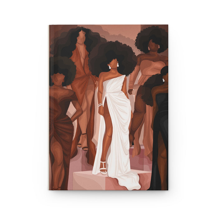 Cover of a matte hardcover journal featuring a full-wraparound print of a black and brown artistic depiction of a woman in a white dress, with other figures in the background.