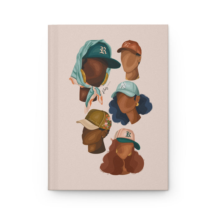 A matte hardcover journal with a full wraparound print featuring various fashion styles, including hats and hairstyles, in a neutral color palette.